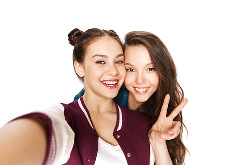 people, friends, teens and friendship concept - happy smiling pretty teenage girls taking selfie and showing peace sign