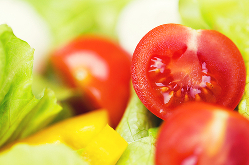 diet, vegetable food, healthy eating and objects concept - close up of ripe cut vegetables in salad