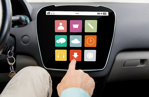 transport, driving, technology, media and people concept - close up of male hand with virtual applications icons on car computer screen