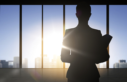 business and people concept - silhouette of woman with folders over office window background