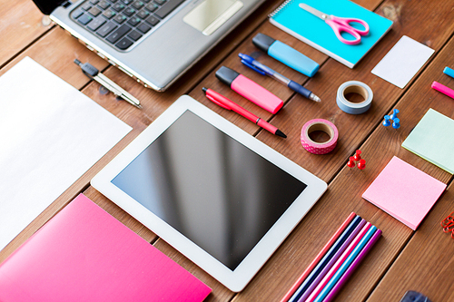 education, school supplies, art, creativity and object concept - close up of stationery and tablet pc computer on wooden table