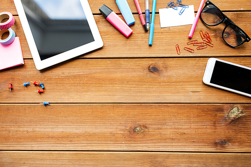 education, school supplies, art, creativity and object concept - close up of stationery and tablet pc computer with smartphone on wooden table