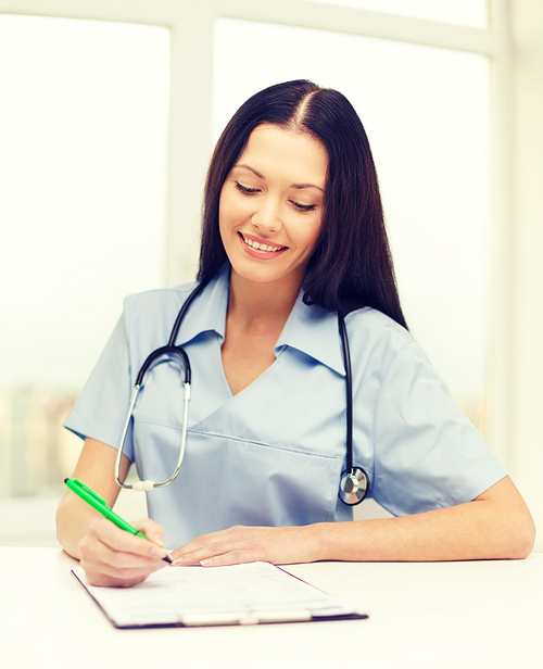 medicine and health concept - female doctor or nurse writing prescription