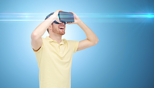 3d technology, virtual reality, entertainment and people concept - happy young man with virtual reality headset or 3d glasses over blue background and laser light