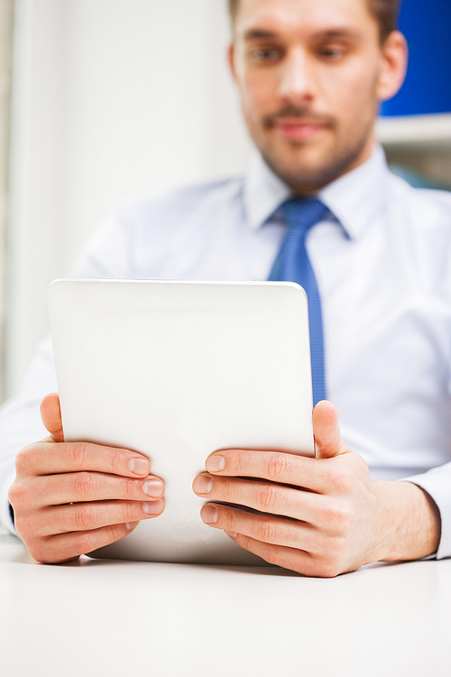 business, education, people and technology concept - close up of businessman with tablet pc in office