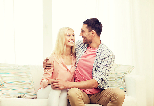 love, family and happiness concept - smiling happy couple at home