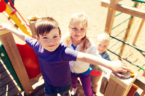 summer, childhood, leisure, friendship and people concept - group of happy kids on children playground