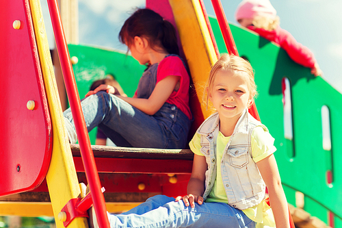 summer, childhood, leisure, friendship and people concept - happy kids on children playground climbing frame