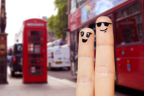 family, couple, travel, tourism and body parts concept - close up of two fingers with smiley faces over london city street background