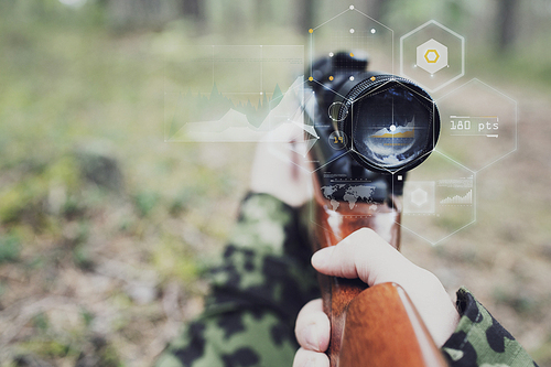 hunting, war, army, technology and people concept - close up of young soldier or sniper hands holding gun with virtual screen projection and aiming in forest