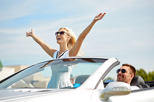 transport, leisure, road trip and people concept - happy man and woman driving in cabriolet car outdoors