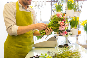 people, business,  and floristry concept - close up of happy smiling florist man making bunch at flower shop