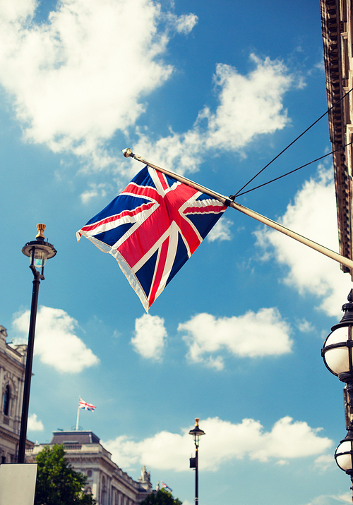 state sybols and national holidays concept - british nion jack flag waving on london city street
