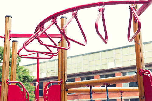 childhood, sport, equipment and object concept - climbing frame on playground outdoors at summer