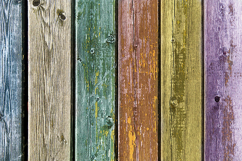 backgrounds and texture concept - old wooden fence painted in different colors background