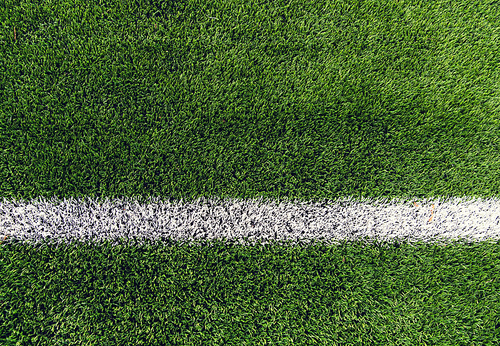 sport and game concept - close up of football field with line and grass