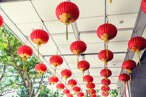asia, tradition and holidays concept - ceiling decorated with hanging chinese lanterns