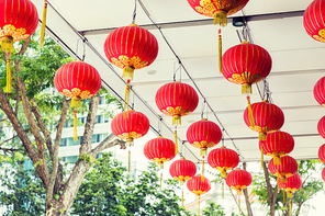 asia, tradition and holidays concept - ceiling decorated with hanging chinese lanterns