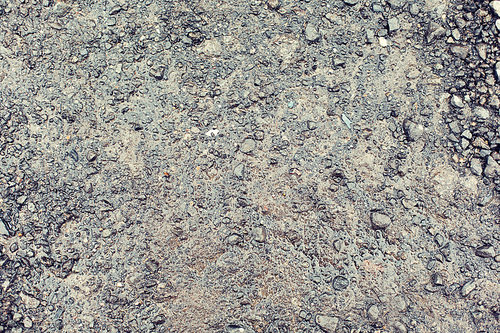 background and texture concept - close up of wet gray gravel road or ground