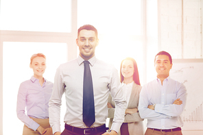business and office concept - smiling handsome businessman with team in office