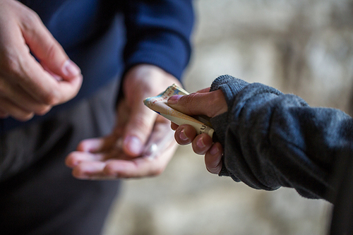 drug trafficking, crime, addiction and sale concept - close up of addict with money buying dose from dealer on street