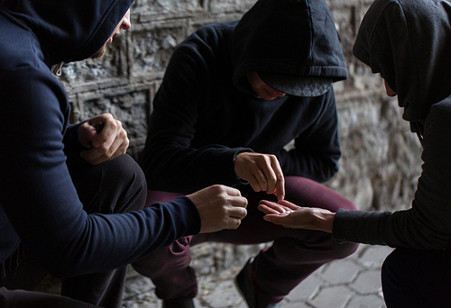 substance abuse, addiction and people concept - close up of addicts using drugs outdoors