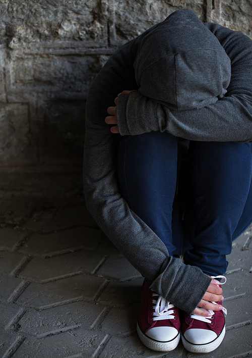 substance abuse, addiction, people and social issue concept - close up of addict woman hiding her face on street