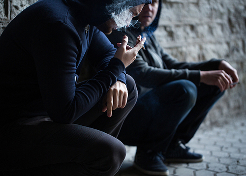 substance abuse, addiction, people and bad habits concept - close up of young men smoking cigarettes outdoors