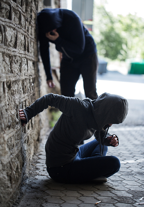 substance abuse, addiction, people and drug use concept - close up of addicts and used syringes on ground