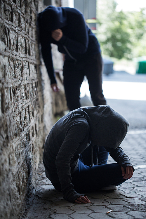 substance abuse, addiction, people and drug use concept - close up of addicts on street