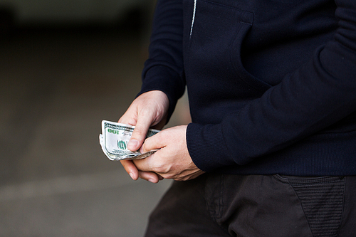 drug trafficking, finances, addiction, people and sale concept - close up of addict or dealer hands with dollar money