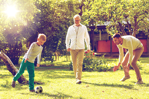 family, happiness, generation, home and people concept - happy family playing football in front of house outdoors