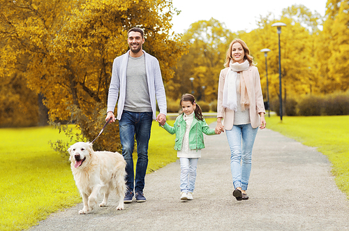 family, pet, domestic animal and people concept - happy family with labrador retriever dog walking in autumn city park