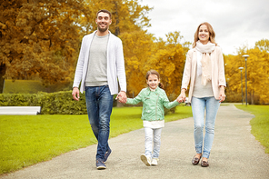 family, parenthood, adoption and people concept - happy mother, father and little girl walking in autumn park