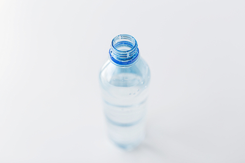 recycling, healthy eating and food storage concept - close up of open plastic bottle with pure  water on table