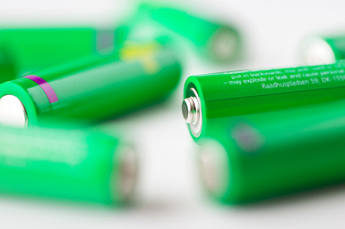 recycling, energy, power, environment and ecology concept - close up of green alkaline batteries