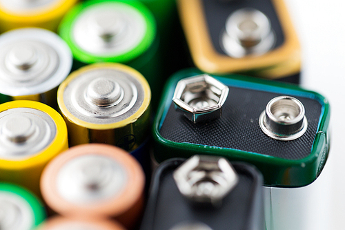 recycling, energy, power, environment and ecology concept - close up of alkaline batteries heap