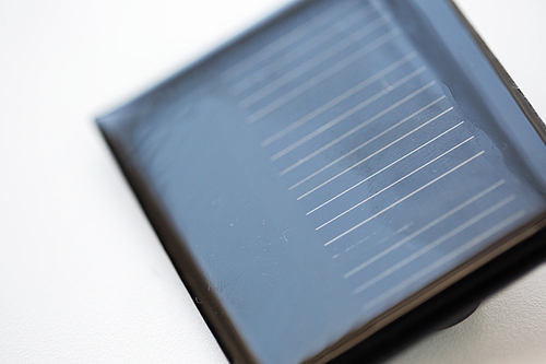 recycling, energy, power, environment and ecology concept - close up of solar battery or cell