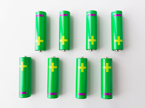 recycling, energy, power, environment and ecology concept - close up of green alkaline batteries
