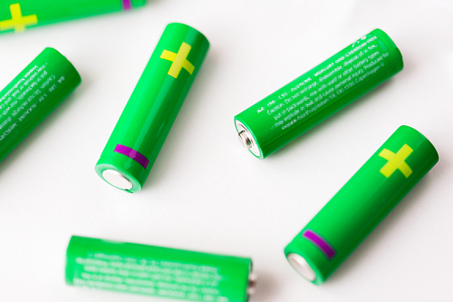 recycling, energy, power, environment and ecology concept - close up of green alkaline batteries