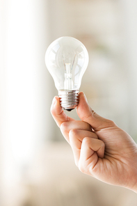 recycling, electricity, idea, environment and ecology concept - close up of hand holding lightbulb or incandescent lamp