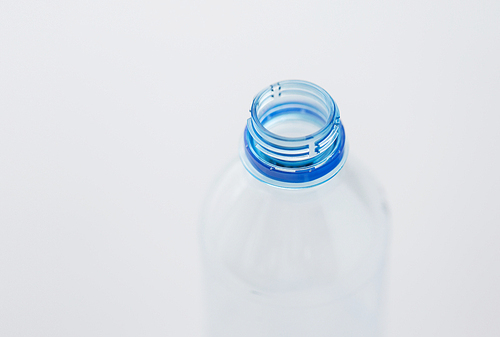 recycling, healthy eating and food storage concept - close up of clean empty used plastic water bottle neck