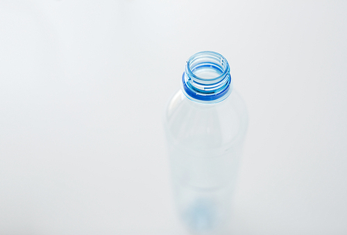 recycling, healthy eating and food storage concept - close up of clean empty used plastic water bottle on table