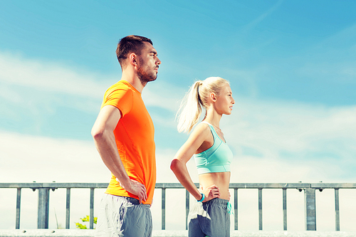 fitness, sport, friendship and healthy lifestyle concept - sporty couple outdoors