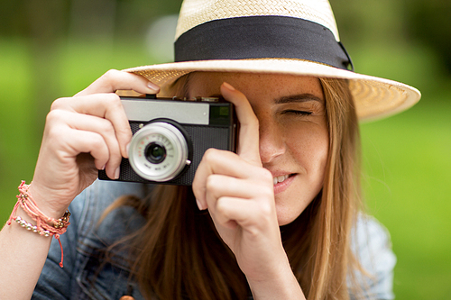 photography and people concept - close up of young woman with camera photographing outdoors
