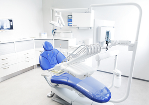 dentistry, medicine, medical equipment and stomatology concept - interior of new modern dental clinic office with chair