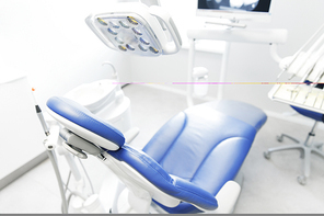dentistry, medicine, medical equipment and stomatology concept - interior of new modern dental clinic office with chair