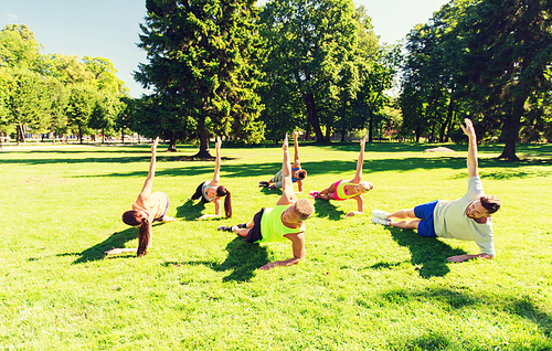 fitness, sport, friendship and healthy lifestyle concept - group of happy teenage friends exercising at boot camp