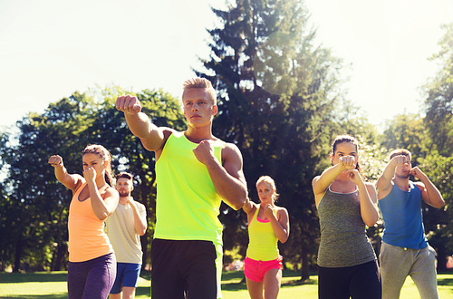 fitness, sport, martial arts, self-defense and healthy lifestyle concept - group of teenage friends or sportsmen exercising and at boot camp