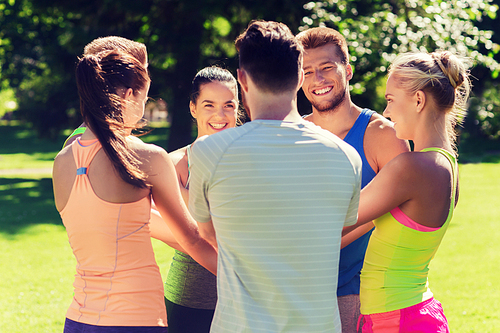 fitness, sport, friendship and healthy lifestyle concept - group of happy teenage friends or sportsmen with hands on top outdoors